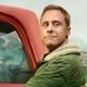 Promotional art for Syfy's Resident Alien, showing Alan Tudyk's Harry in both his human and alien forms.
